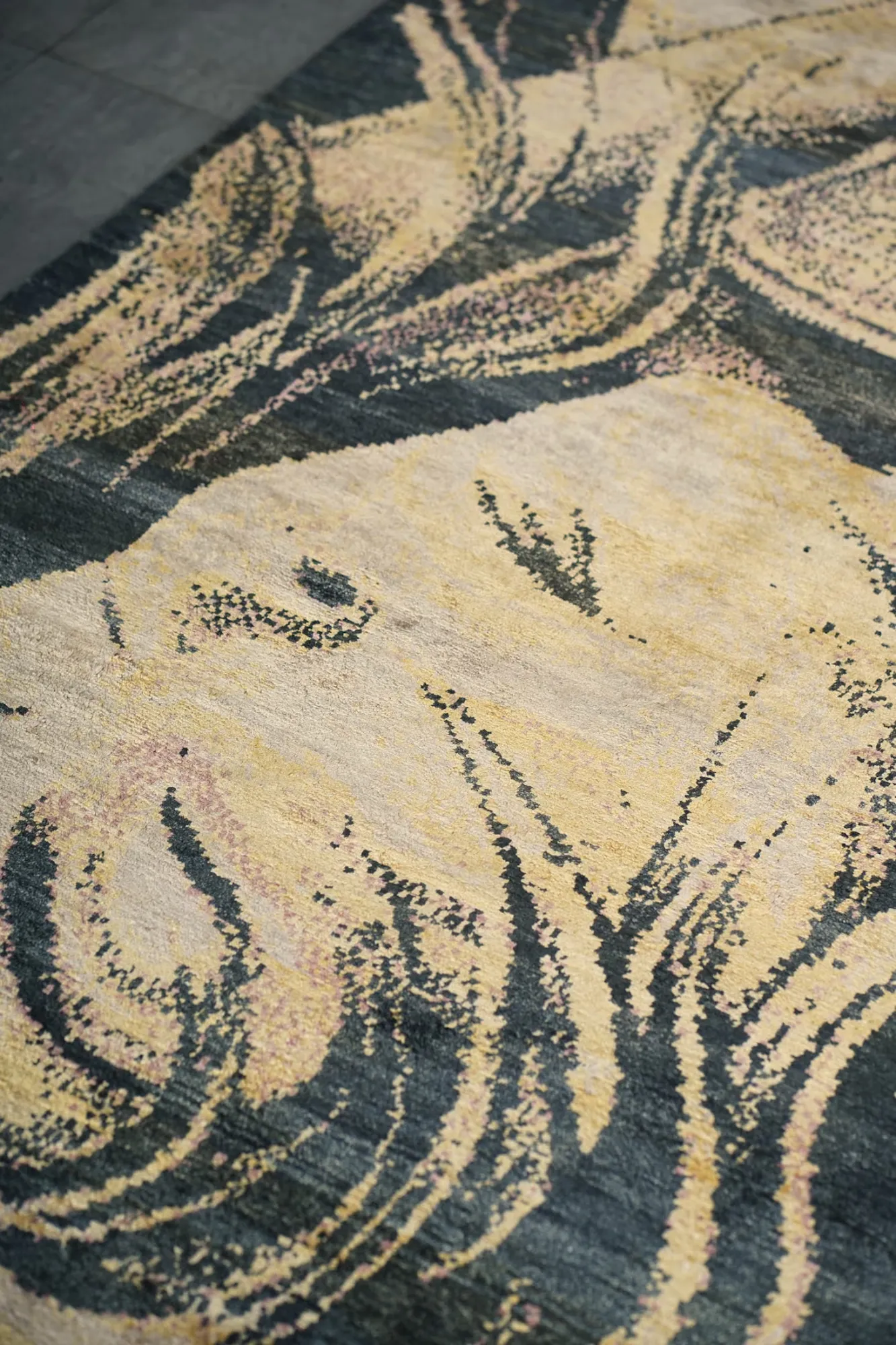 Close view of the pile: gold and charcoal silk around her face